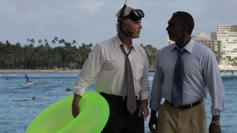 Businessmen walking on a beach with an inflatable. Stock-Footage 88369368