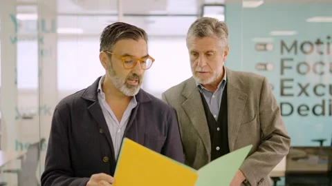 Businessmen walking while reading a financial report on paper Video stock 266672189