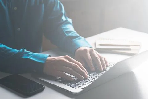 Businessmen work on computers and write on notepad. Stock Photos
