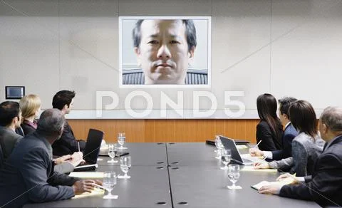 Businesspeople attending video conference Stock Photos