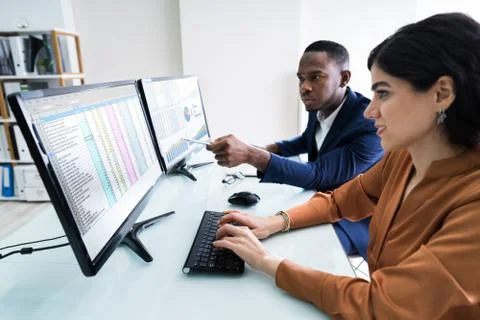 Businesspeople Checking Spreadsheet On Screen Stock Photos