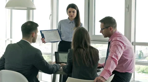 Businesspeople comparing graphs on papers and tablet Stock-Footage 50739959