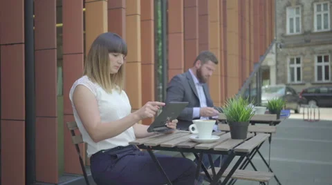 Businesspeople consulting data on tablet during work. Outdoor. Steadycam shot. 動画素材 65361348