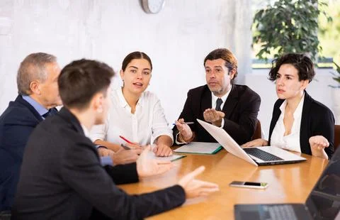 Businesspeople developing strategy for teamwork at table in office Stock Photos