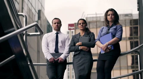 Businesspeople doing serious look to the camera and holding files Stock Footage 44211700