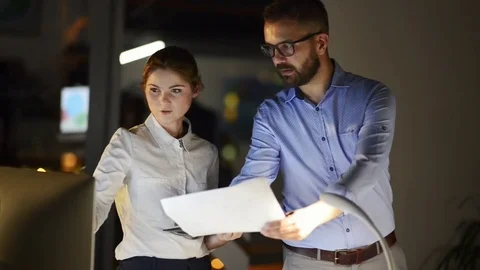 Businesspeople in the office at night working late. Stock Footage