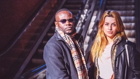 Businesspeople posing at camera in front of escalators at train station Stock Footage 86468446