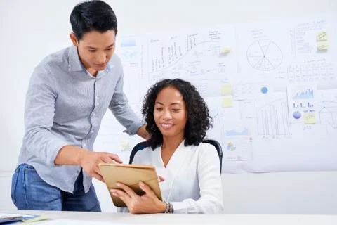 Businesspeople reding data on tablet computer Stock Photos