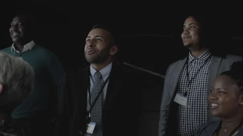Businesspeople smiling during a presentation on a multiscreen office wall Stock Footage 138137855