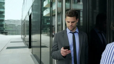 Businesspeople standing in the queue and using smartphones, steadycam shot Stock Footage 54590365