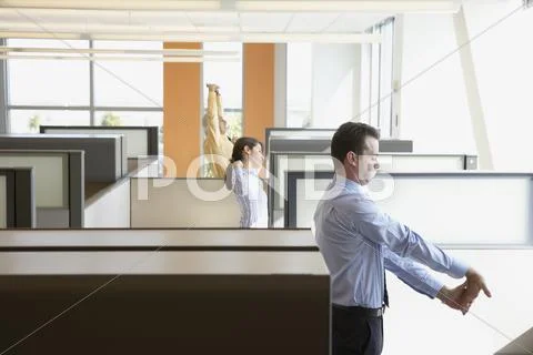 Businesspeople stretching in their cubicles Stock Photos