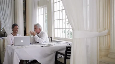 Businesspeople using a laptop in a restaurant. Stock Footage 88369101