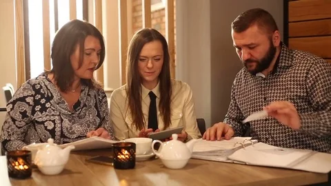 Businesspeople working on papers while having lunch Stock Footage 72132516