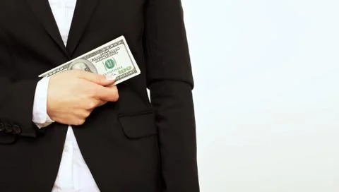 Businessperson in black holding a dollar bill Stock Photos