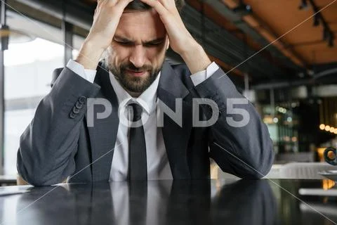 Businessperson on business lunch at restaurant sitting concerned unhappy Stock Photos