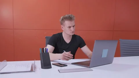 Businessperson handsome guy is typing using laptop computer indoors Stock Footage 141664120