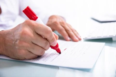 Businessperson Marking Error With Marker On Document Stock Photos