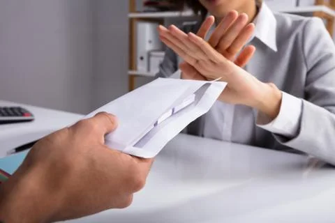 Businessperson Refusing Bribe Given By Partner In Envelope Foto stock