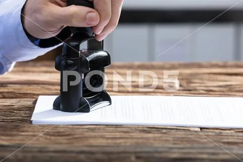 Businessperson Stamping With Approved Stamp On Document Stock Photos