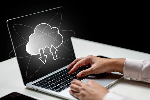 Businessperson using a laptop with cloud computing icon on the screen. Tech.. Stockfoto's