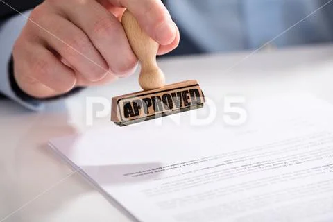 Businessperson Using Stamper On Document With Approved Text Stock Photos