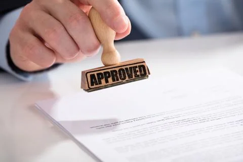Businessperson Using Stamper On Document With Approved Text Stock Photos