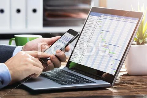 Businessperson Working With Gantt Chart On Mobile Phone Stock Photos