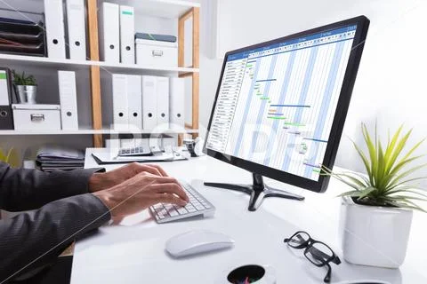 Businessperson Working On Gantt Chart Using Computer Stock Photos