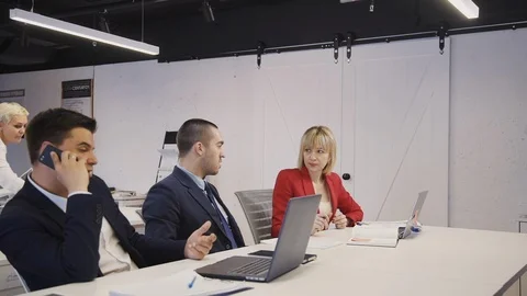 Businessperson working together, talking using laptop, smartphon Stock Footage 119421423