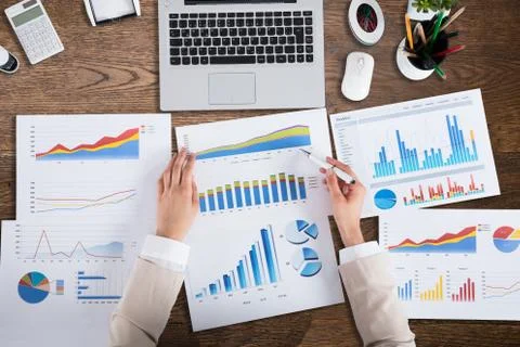 Businessperson's Hand Analyzing Graph Stock Photos