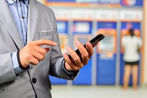 Businesssman using Mobile Banking Application on Smartphone Stock Photos