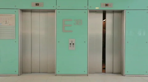 Businessteam of three out of elevator TWO TAKES Stock Footage 492227