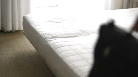 Businesstraveler relaxing in bed Stock Footage 1042472