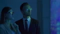 The businesswoman and a businessman discussing near the big display 4k or 4k+ Resolution