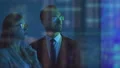 The businesswoman and a businessman discussing near the big screen 4k or 4k+ Resolution