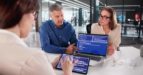 Businesswoman And Programmer Collaborating On Software Design At Office Meeti Stock Photos