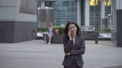 Businesswoman approaching to camera while talking Stock Footage 76189336