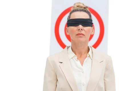 Businesswoman blindfolded and target behind Stock Photos