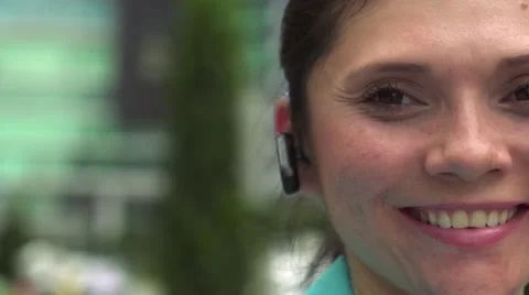 Businesswoman with bluetooth device looking at camera smiling Stock Footage 44370586