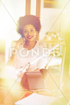 Businesswoman calling on smartphone at office Stock Photos