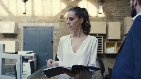 Businesswoman checking a file while walking around office Stock Footage 107891522