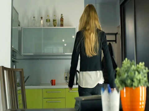 Businesswoman coming home and make herself a coffee, steadycam shot Stock Footage