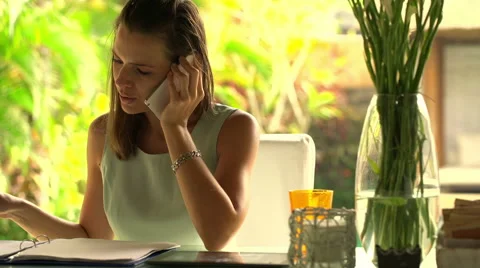 Businesswoman comparing data on tablet and documents during telephone calling HD Stock Footage 44129678
