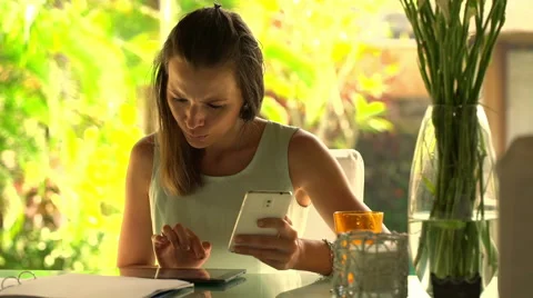 Businesswoman comparing data on tablet and smartphone on by table HD Stock Footage 44134035