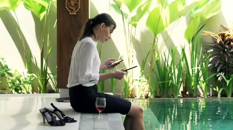 Businesswoman comparing data on tablet computer and smartphone sitting on the ed Stock Footage 64271754