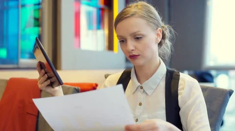 Businesswoman comparing documents and data on tablet, steadycam shot Stock Footage 66521978