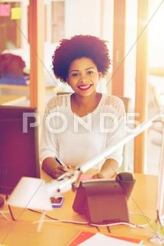 Businesswoman with computer and phone at office Stock Photos