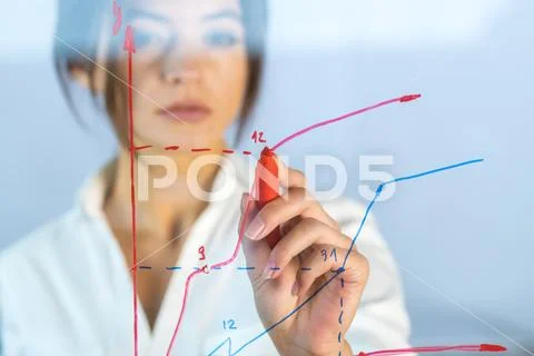 The businesswoman draw the graph at the virtual screen Stock Photos