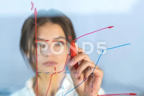 The businesswoman draw the graph at the virtual screen Stock Photos