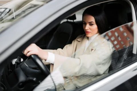 Businesswoman driving the luxury car Stock Photos